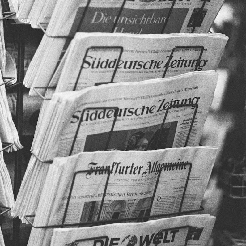 a stack of newspapers sitting next to each other
