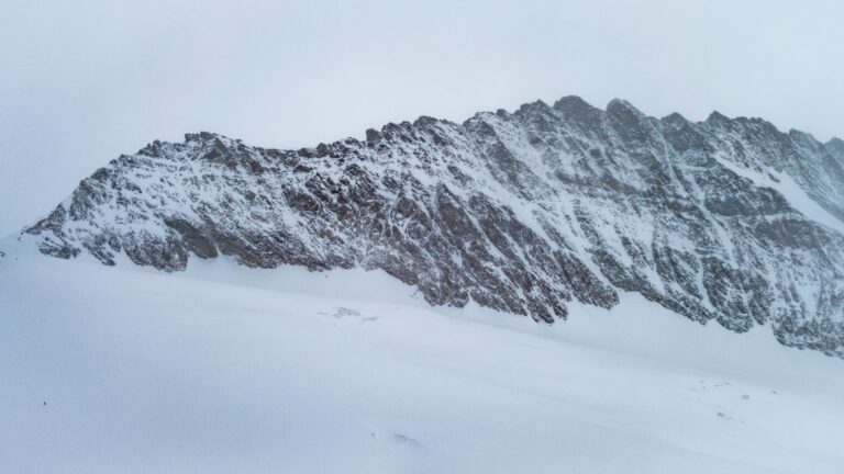 a mountain covered in snow with a person on skis